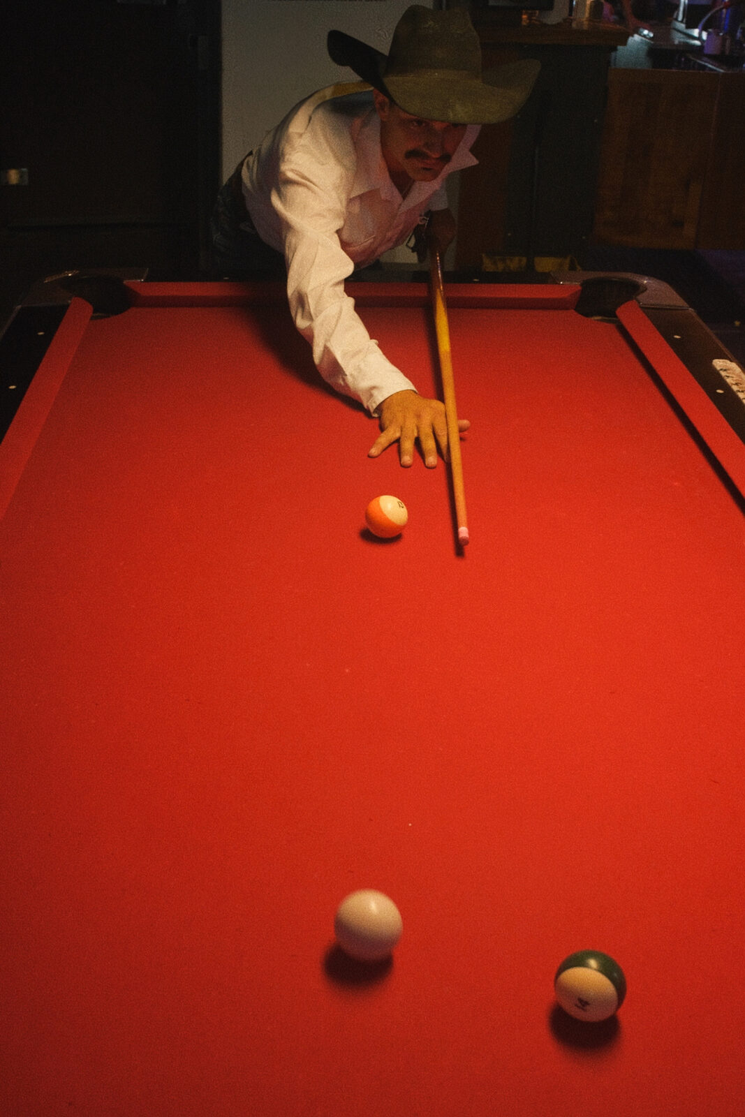 A cowboy at the pool hall